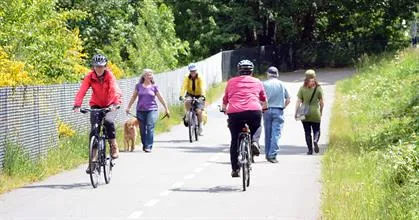 Photograph of people walking and cycling on a paved trail