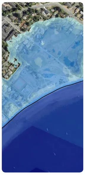 Aerial map with a light blue overlay showing potential coastal flooding areas