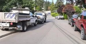 Two town maintenance trucks parked on the sidewalk of Jedburgh Road