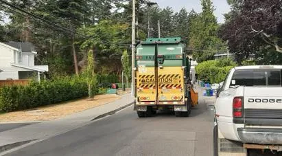 Two town maintenance trucks parked on the sidewalk of Jedburgh Road