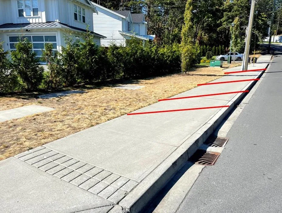 Sidewalk area along Jedburgh Rd with red lines superimposed to show suggested angled parking layout