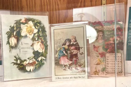 close-up of vintage holiday cards and ornaments in a display case