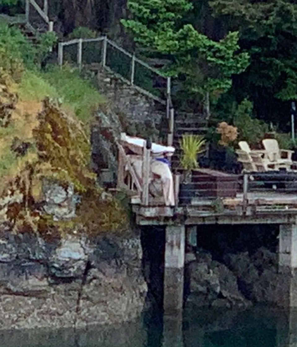 Photo 3. Photo looking east from the water at the dock and proposed shed location within the footprint of the previously constructed area: an existing dock, concrete pad, previously cleared bedrock, and stacked rock wall.