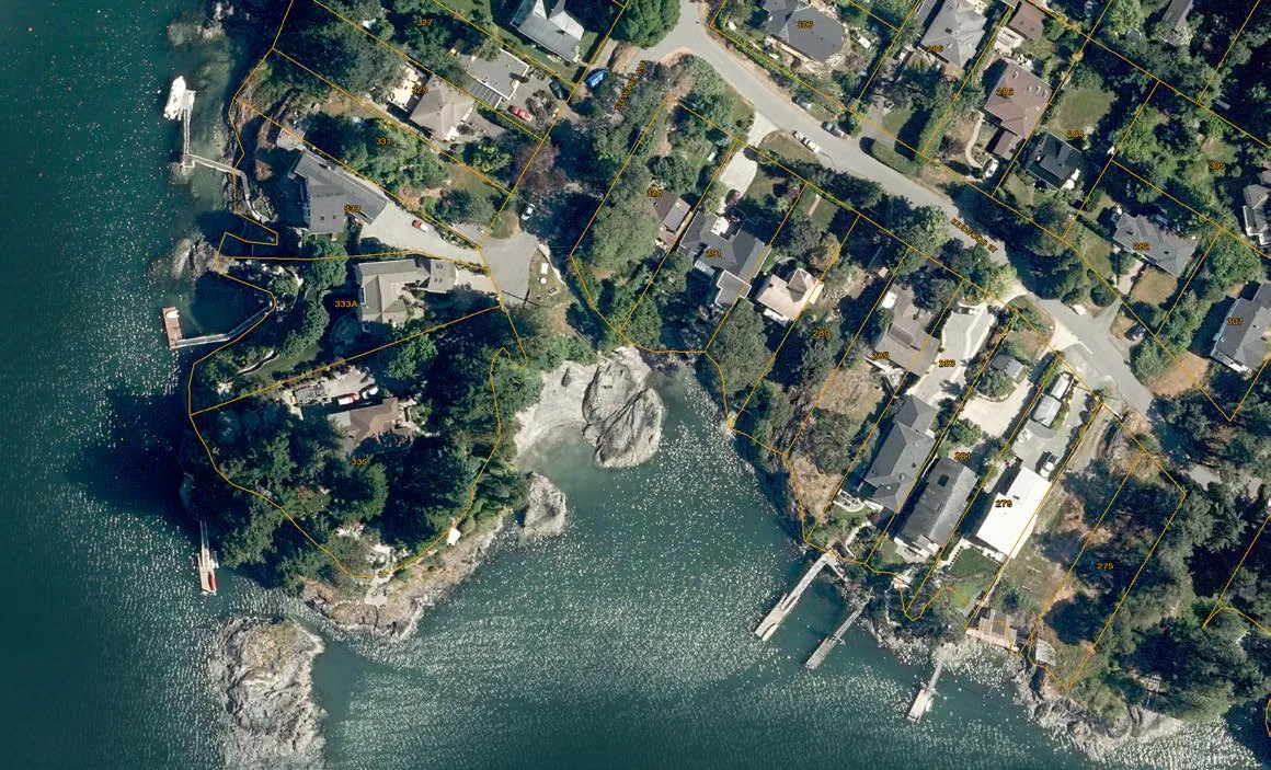 Aerial photograph of 335 Stewart Ave and surrounding properties on Esquimalt Harbour, with a red arrow indicating the proposed boathouse location
