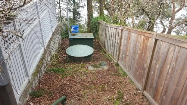 Wide view of the old rusted wet well lid at the Norquay pump station