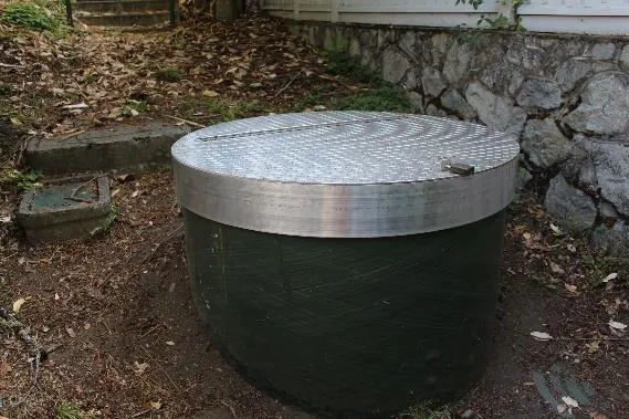 Close-up view of the new aluminum wet well lid with a secure locking mechanism