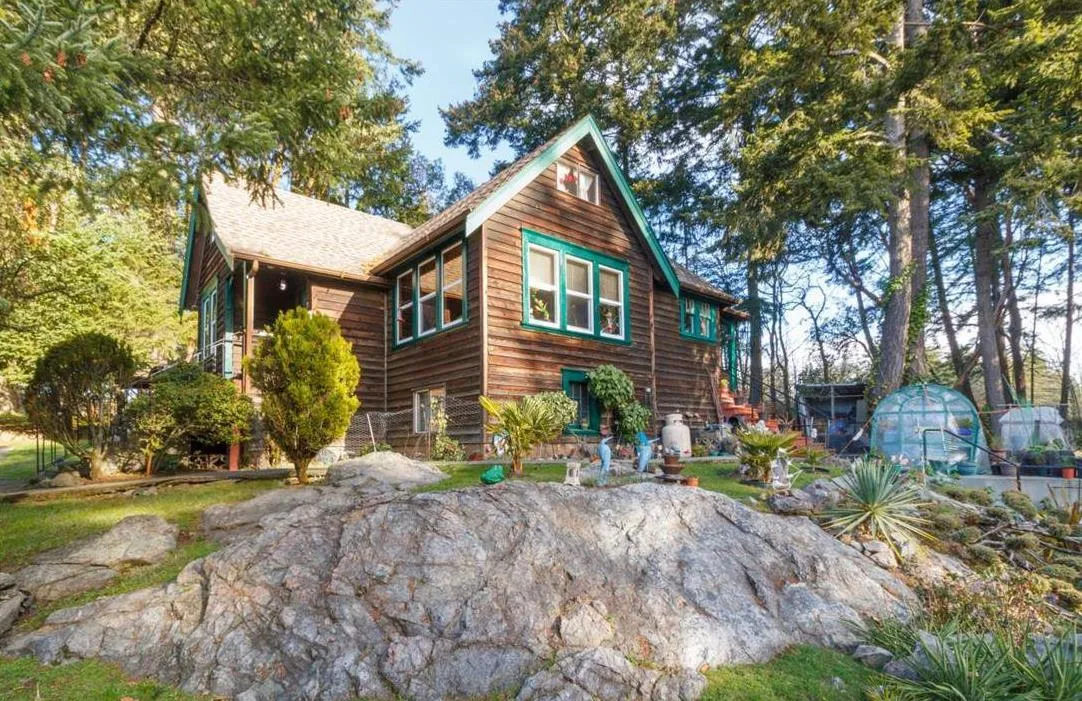 Photograph of an original wooden house on the property