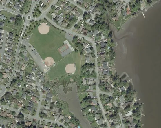Aerial view of Helmcken Centennial Park showing baseball diamonds and proximity to the water