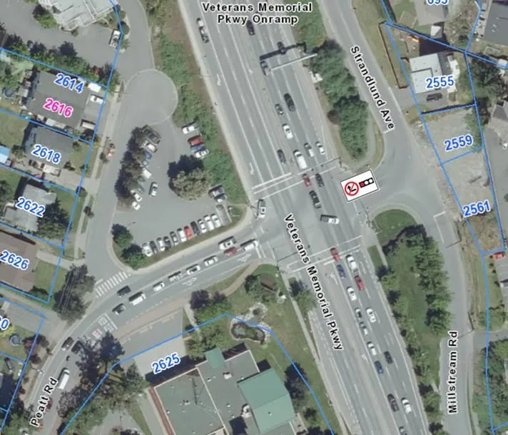 Aerial map of the Veterans Memorial Parkway and Strandlund Avenue intersection with an overlay of a 'no right turn on red' regulatory sign.
