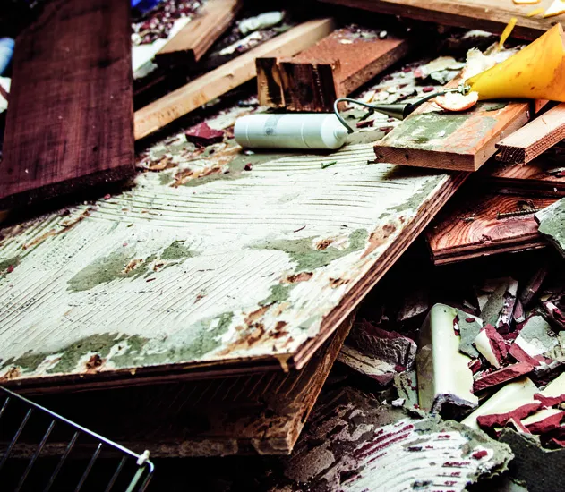 A pile of wood scraps and tiles from a construction site.