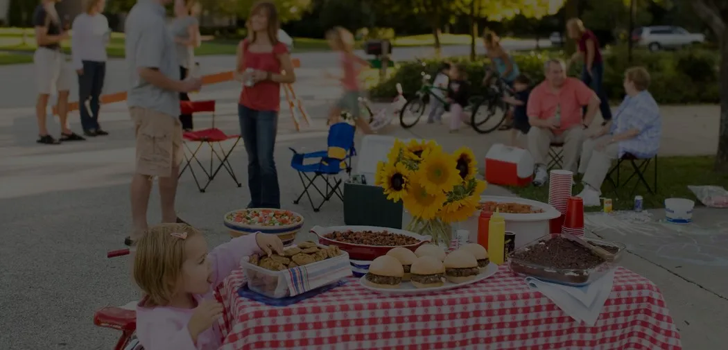 Table set for a block party with food and sunflowers