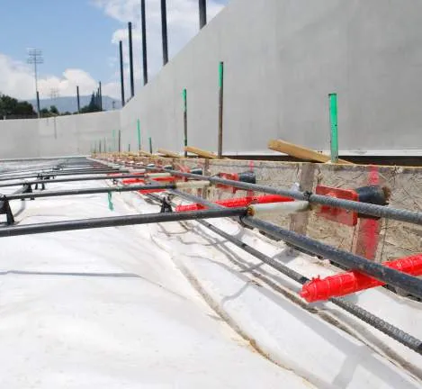 Close-up view of rebar and vapor barrier installation for pickleball court construction