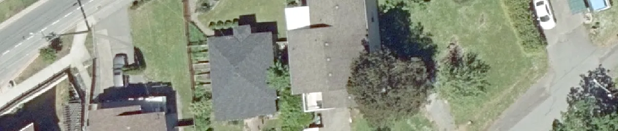 Aerial detail of residential buildings and paved driveway areas