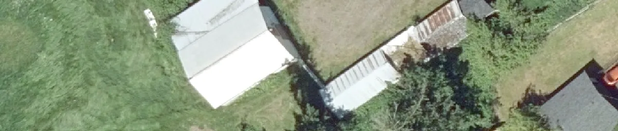 Aerial detail of a cluster of small outbuildings and a yard area