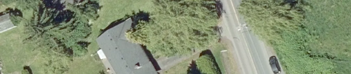 Aerial detail of a building roof and adjacent parking area