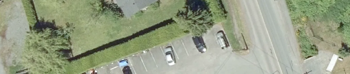 Aerial detail of a road intersection with white lane markings