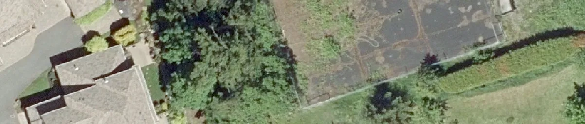 Aerial detail of a large multi-unit building roof and lawn