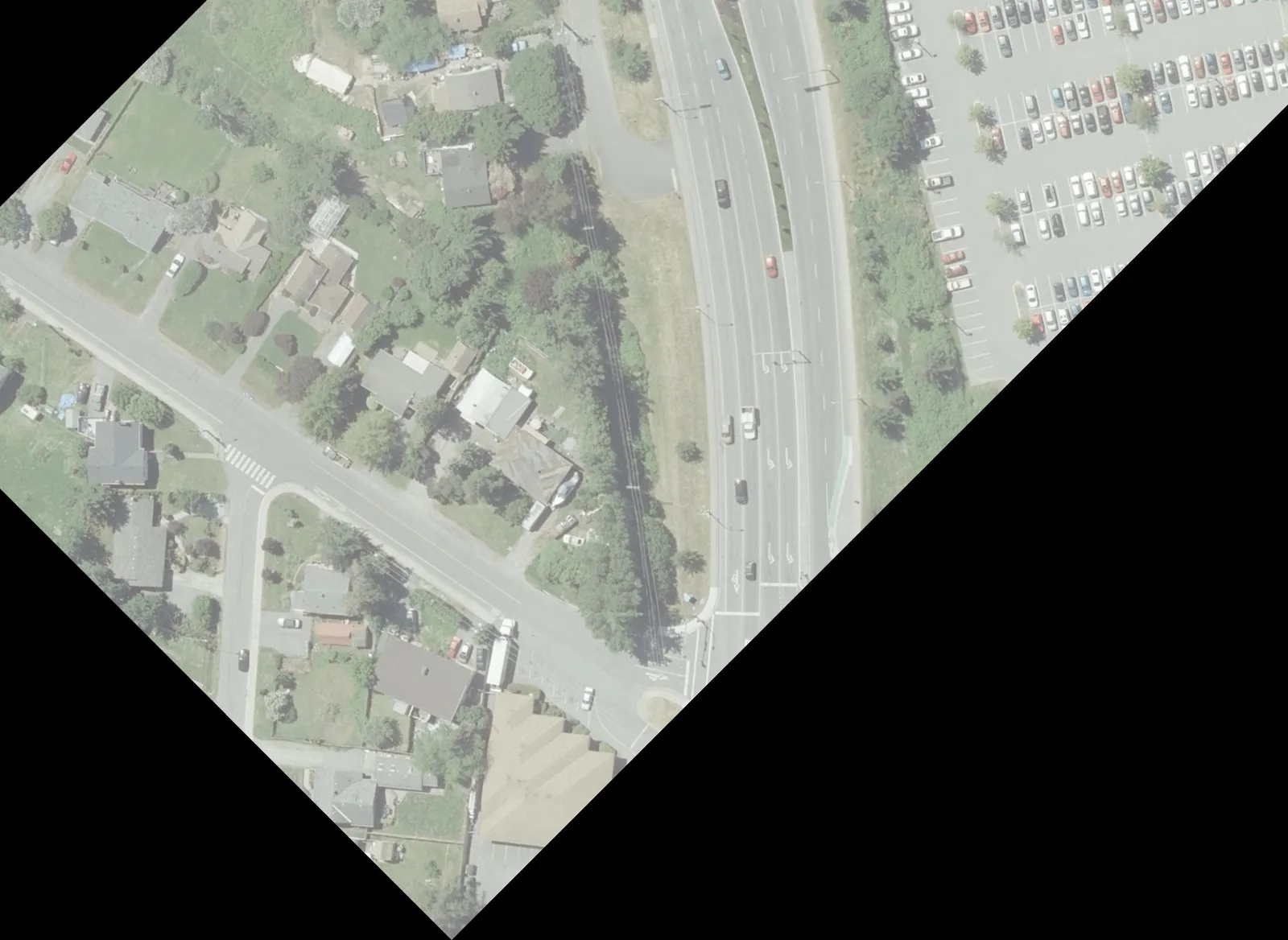Aerial view of Helmcken Road, a parking lot, and surrounding landscape