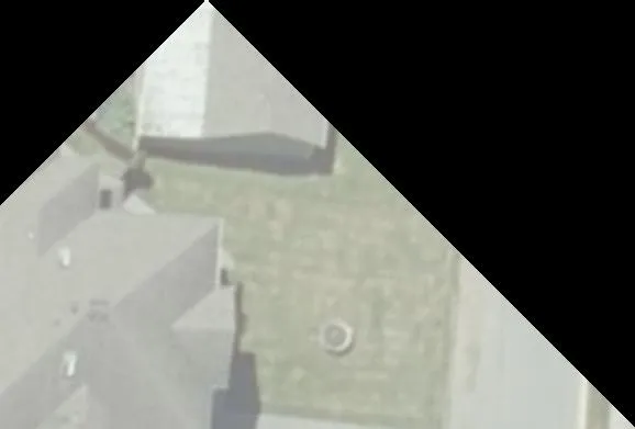 Aerial view of building rooftop and yard area