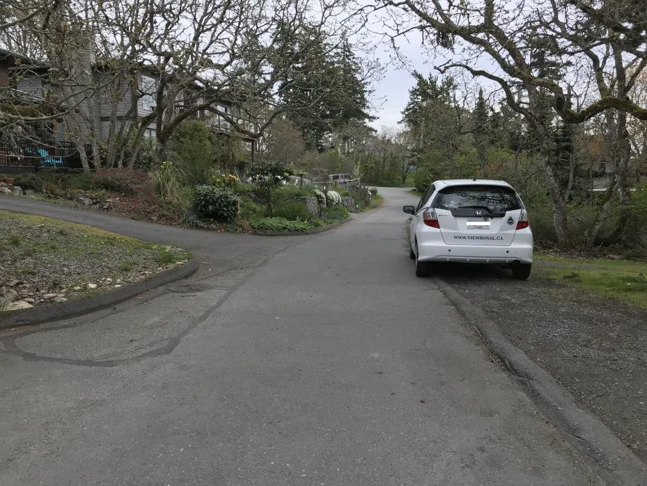 Photo depicting a truck parked on a road shoulder near a centre line
