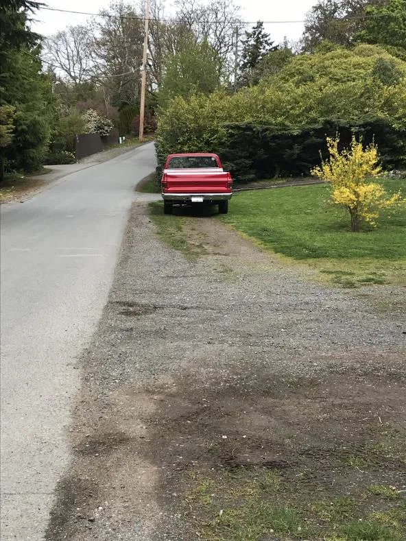 Photo depicting two blue cars parked on opposite sides of a road
