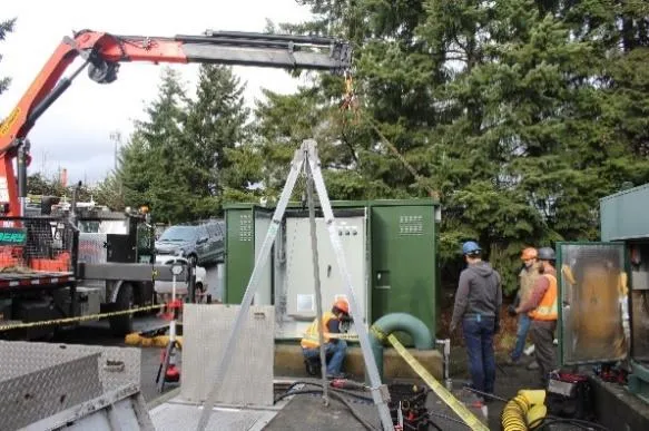 Craning the new electric control kiosk into place at the Hospital pump station