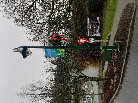 Christmas banners and hanging baskets installed on a lamp post