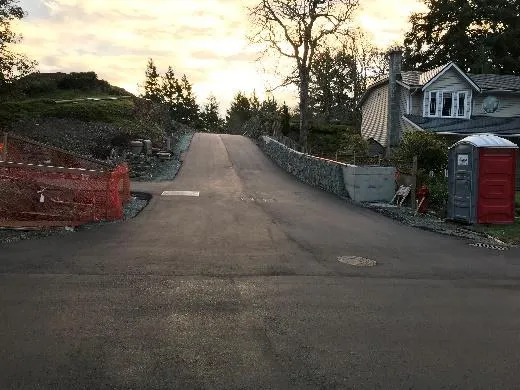 Paved road and retaining wall at 231 Heddle Subdivision