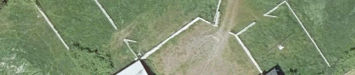 Aerial view of a green field with angled white lines