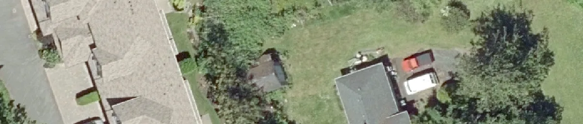 Aerial view of residential buildings and a red truck in a driveway