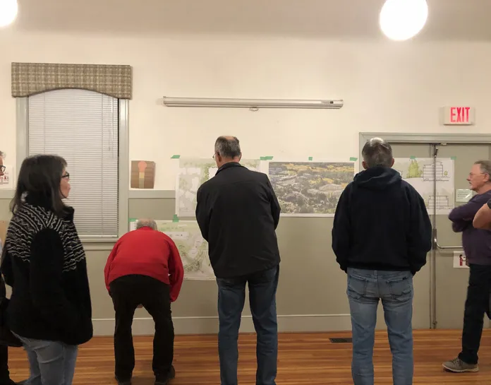 Photo of attendees at the February 3, 2020 Community Meeting viewing information boards.