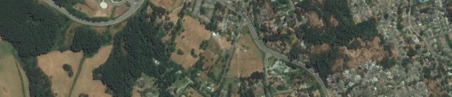 Strip of aerial photo showing project property with red boundary