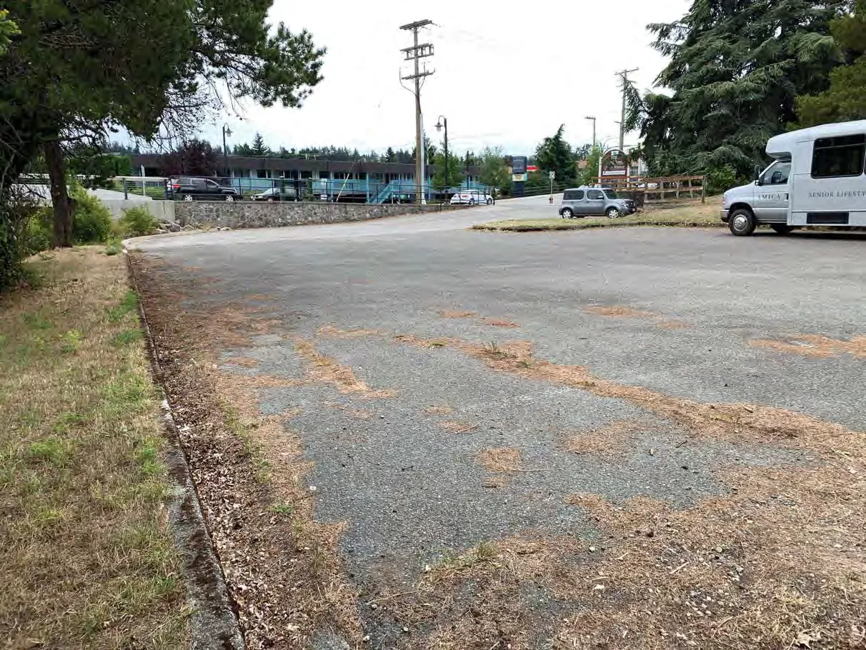 Photo 6. Parking lot in SDPA to be replaced in existing footprint, bioswale to be installed to treat runoff on along left side of photo, adjacent to the parking area.