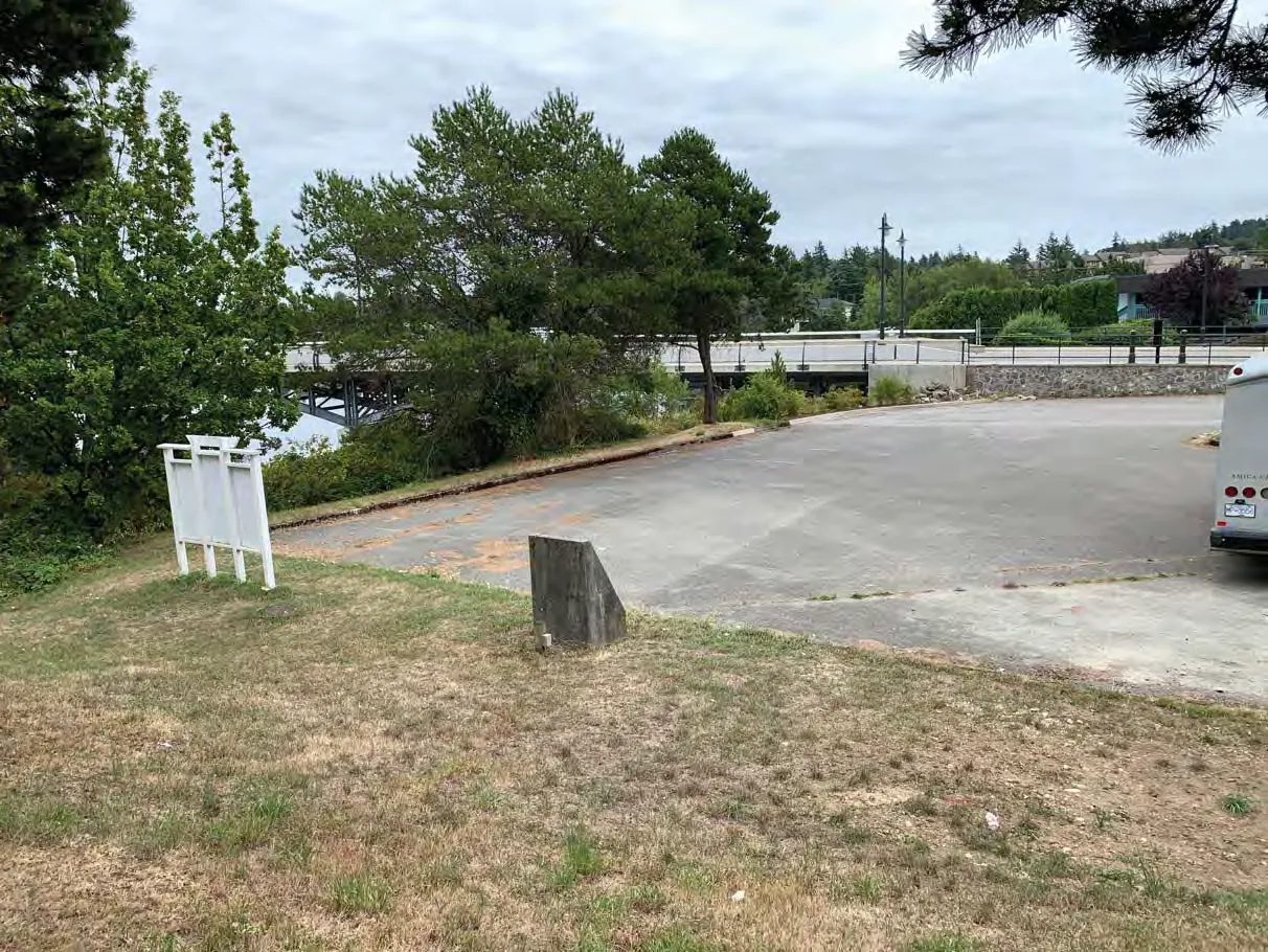 Photo 7. Parking lot in SDPA to be replaced in existing footprint, raingarden and bioswale to be installed to treat runoff adjacent to parking area and bridge.