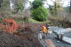 Overview of the Thetis Cove Pump Station Upgrade project site with new walkway and retaining wall