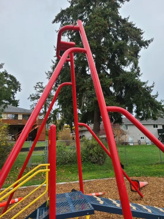 Side view of the repaired red zip line structure at Helmcken Centennial Park