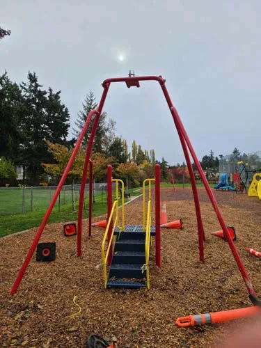 Front view of the zip line structure and surrounding playground area