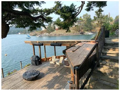 Exterior photo of the partially finished boathouse structure and wharf deck area overlooking the water