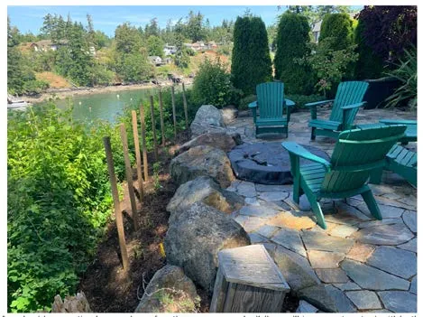 Photo of the existing paver patio area with outdoor chairs and a fire pit