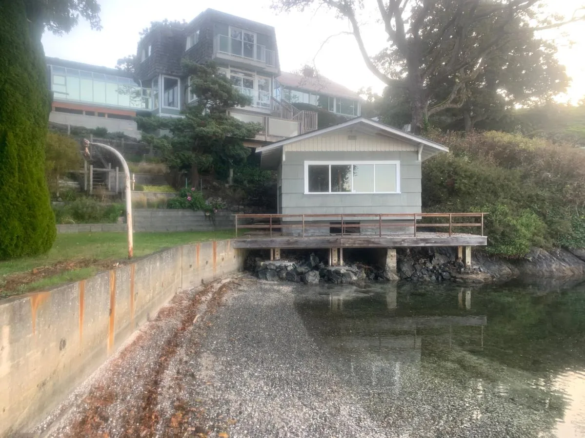 Third example of a neighbor's waterfront building on a rocky shore