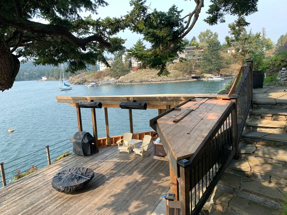 Photo 5. View looking down on the storage shed, over top of existing dock, concrete pad, bedrock and rock wall.