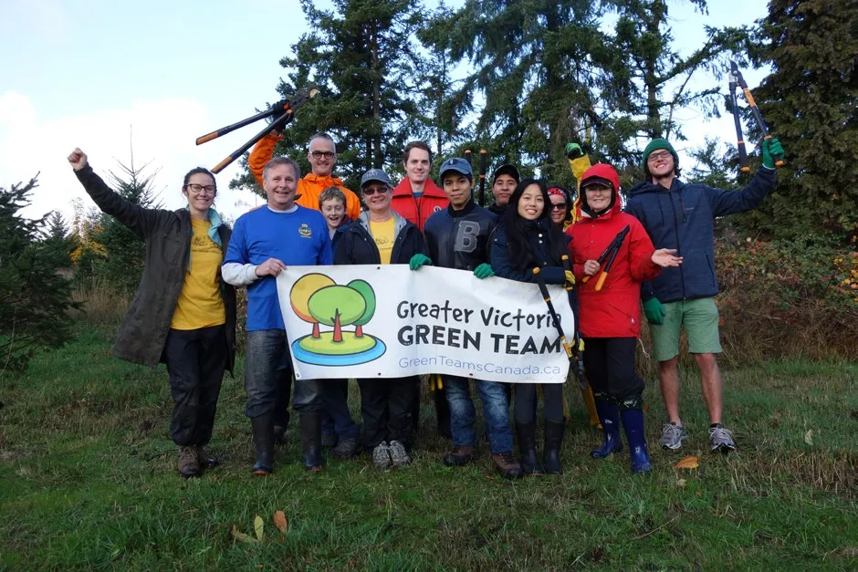 Group photo of volunteers at Chancellor Park holding tools and a Greater Victoria Green Team banner
