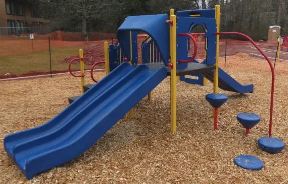 Close-up of the installed tot park equipment and blue double slide