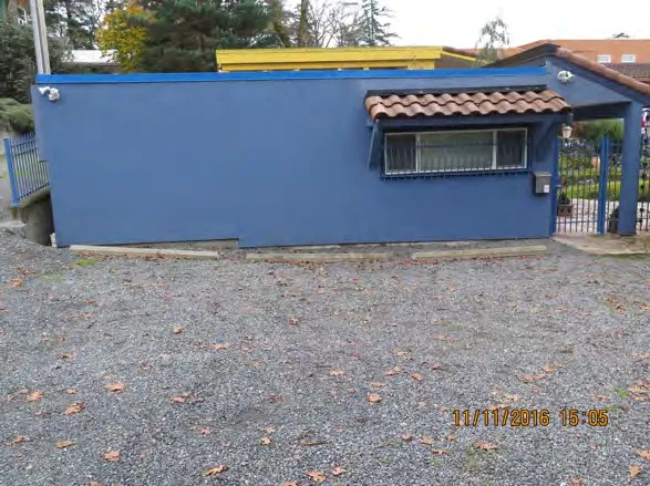 Parking stalls and blue building at end of Grange Road