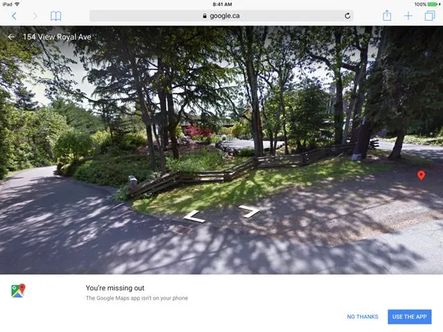 Google Street View screenshot of View Royal Avenue showing a road with a split-rail wooden fence and trees, provided as evidence of no prior driveway