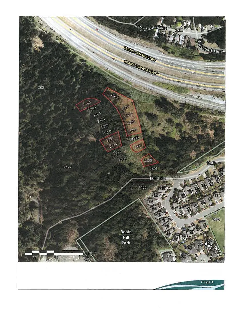 Aerial subject property map showing a series of parcels along Lund Road and adjacent to the Trans-Canada Highway. Highlighted parcels include numbers 2380, 2382, 2384, 2385, 2386, 2387, 2388, 2389, 2390, 2391, 2392, 2393, 2394, 2395, 2396, 2397, 2398, 2399, and 2401. Surrounding landmarks include West Park Lane, Robin Hill Park, and a residential neighborhood with various numbered addresses.