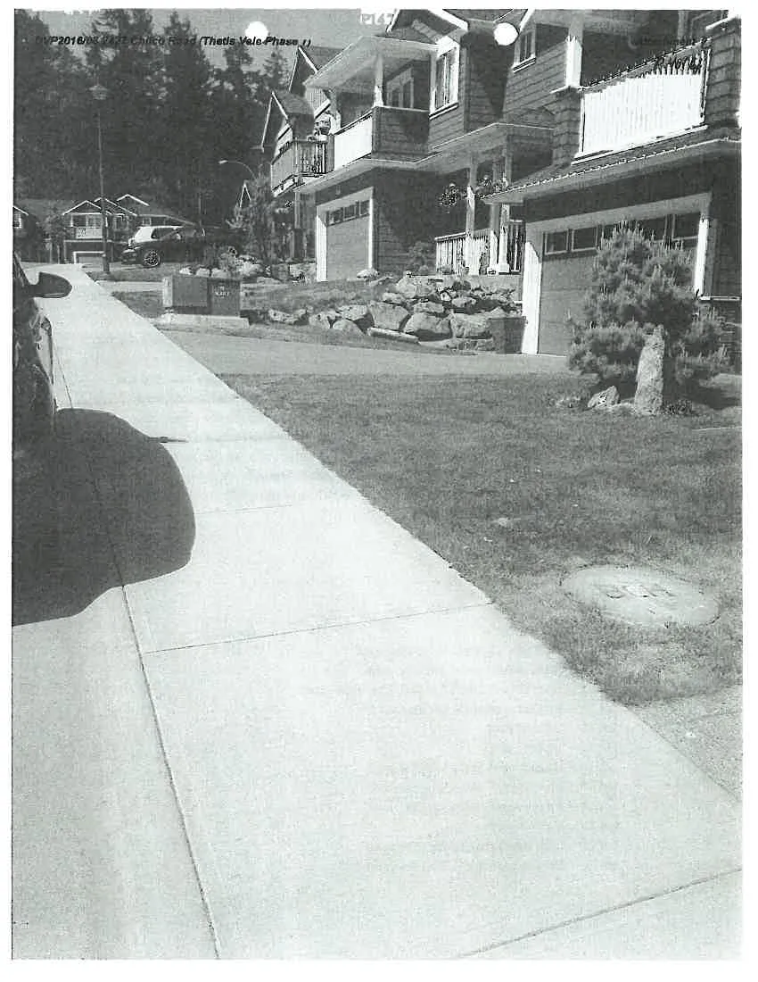 Detail crop showing the upper story and balcony of the house in the Lot 61 photograph