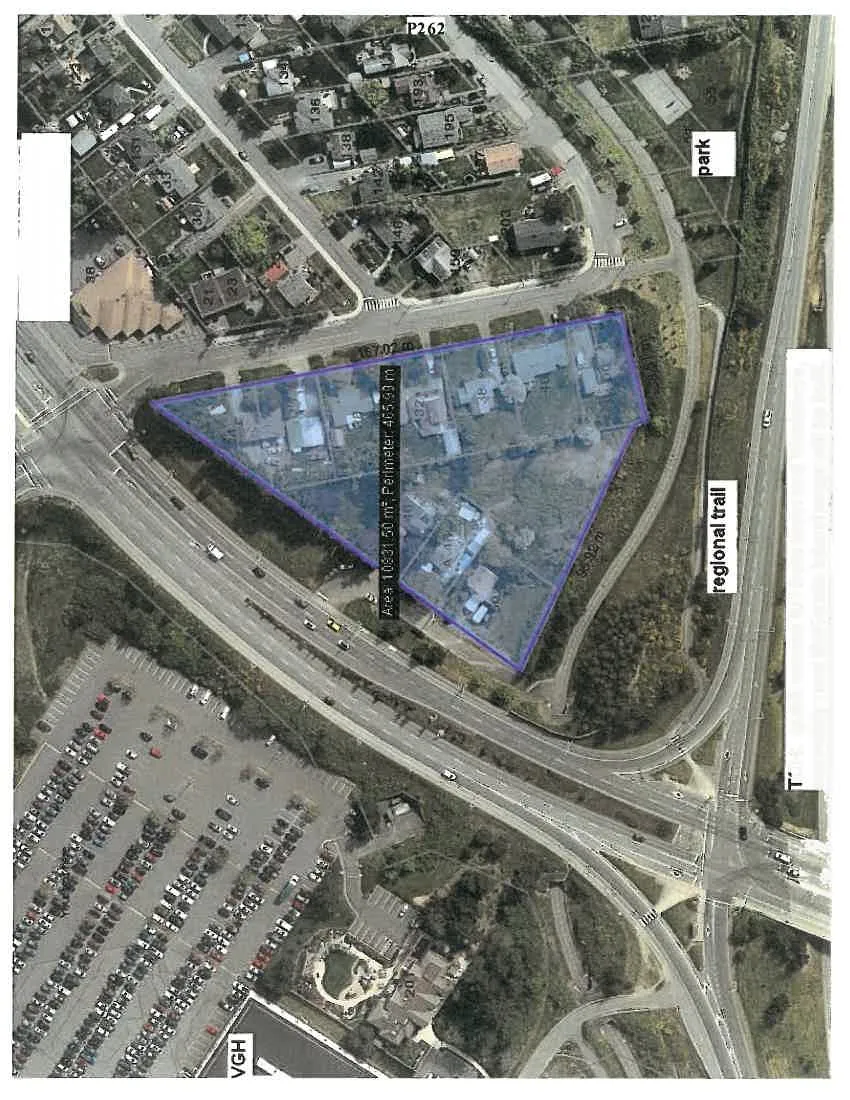 Annotated aerial map highlighting a triangular property area with site measurements, surrounding infrastructure, and local amenities.