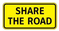 Yellow rectangular sign with "SHARE THE ROAD" text