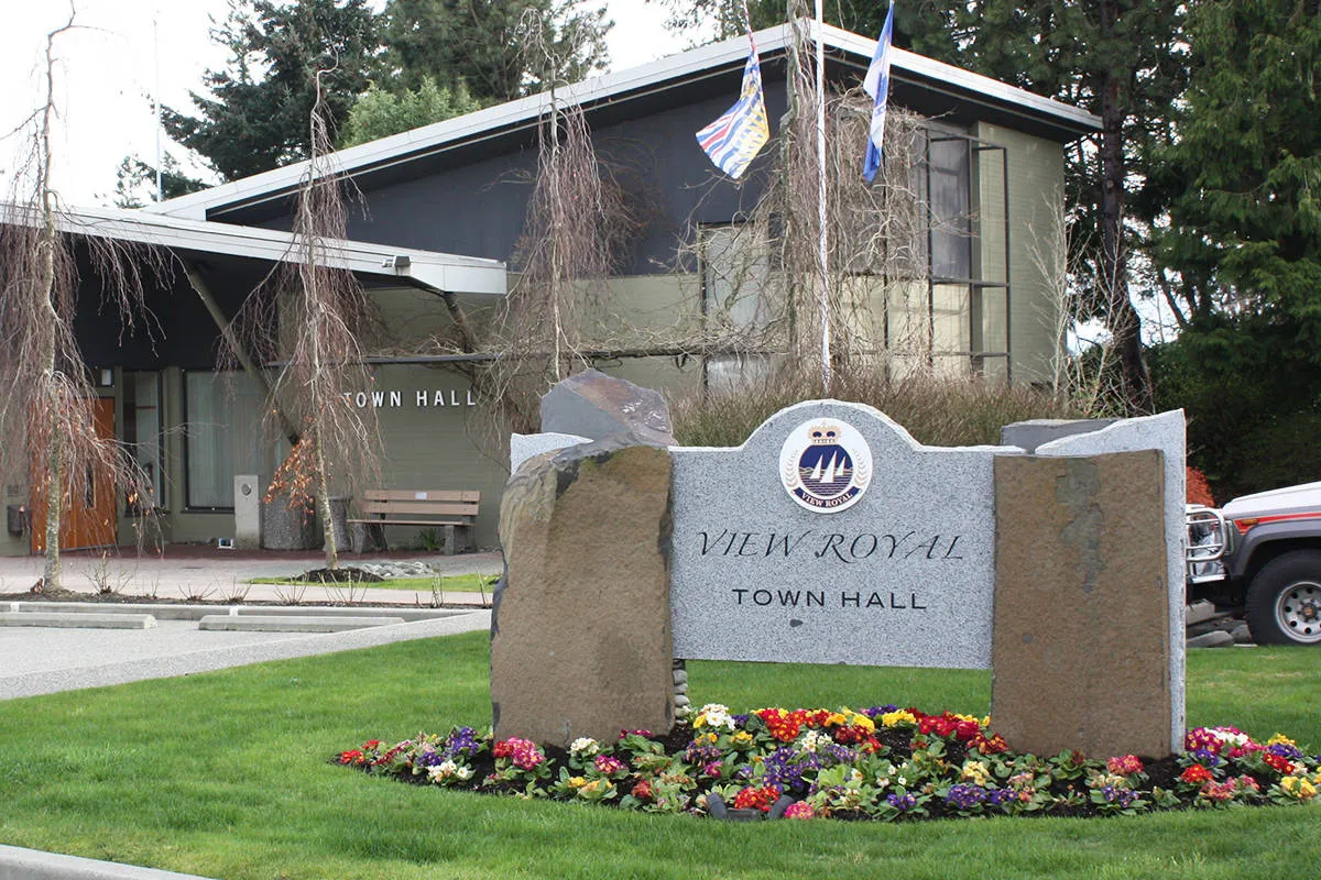 Photo of the View Royal Town Hall and stone entrance sign with a flower garden in the foreground.